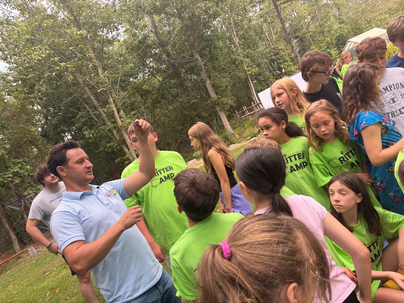 Founder Don Grasso talking with a circle of Critter Camp kids gathered around him