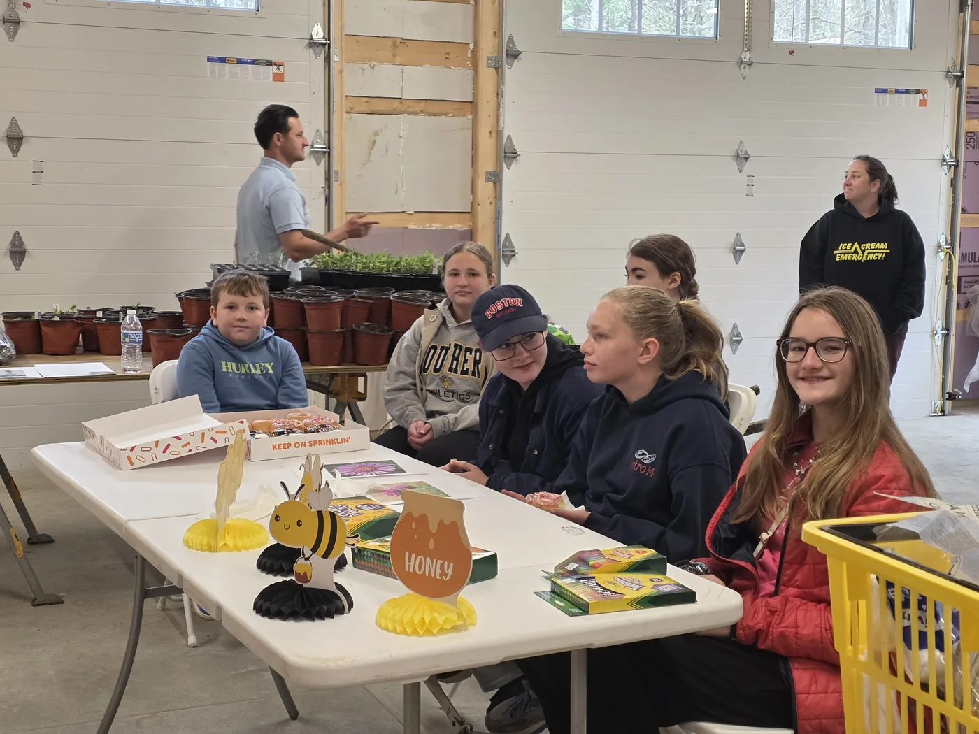 Local Girl Scouts gathered at a table for a bee education day