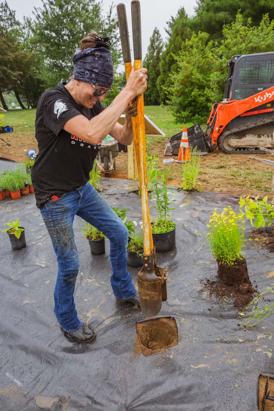 A volunteer digging planting holes at the Kingsway pollinator garden