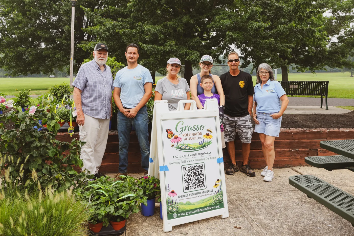 The volunteer crew gathered with the Grasso Pollinator Alliance banner at the end of the day