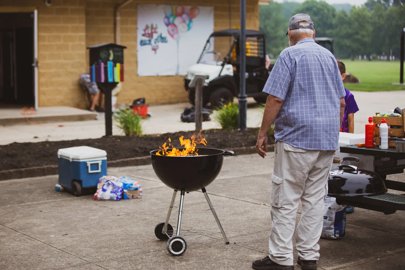 A charcoal grill and coolers set up for the volunteers by the refreshment complex