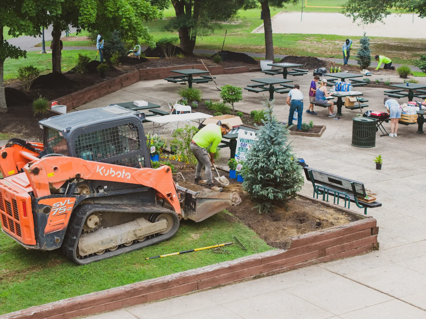 An aerial view of the finished pollinator planting at Washington Lake Park with picnic tables alongside